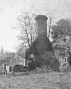 C.1900 image showing the remains of the one of the advance buildings for the Governors Palace. These two flanking structures were all that remained of the 18th century complex. They were reportedly disassembled by Union fatigue details and the bricks were utilized for the improvement of Fort Magruder. Photo in the collections of Colonial Williamsburg. 